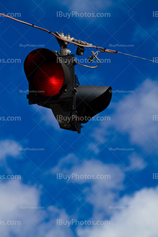 Road sign on wire with clouds in the sky