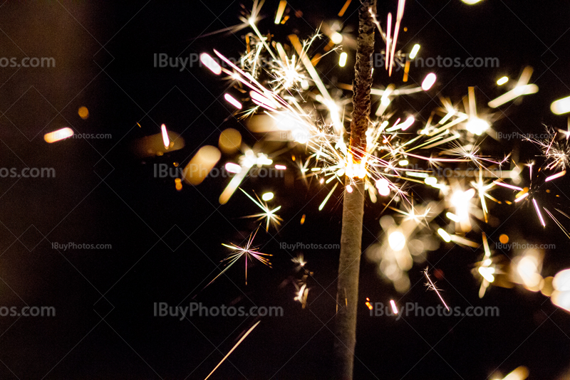 Sparkler burning with sparkles and light