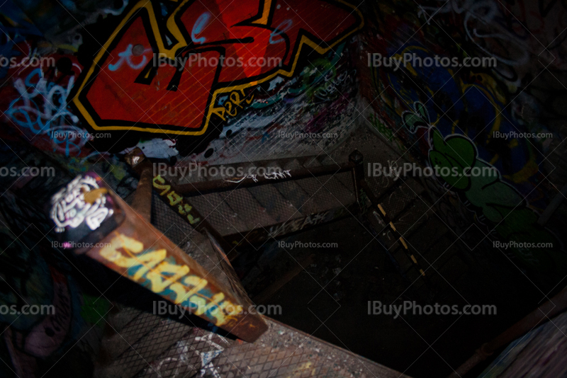 Dark staircase in abandoned building with graffiti