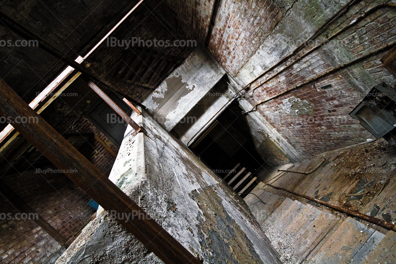 Stairs in abandoned building with bricks walls