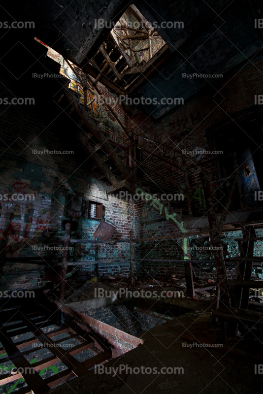 Rusty stairs in dilapidated factory with light painting