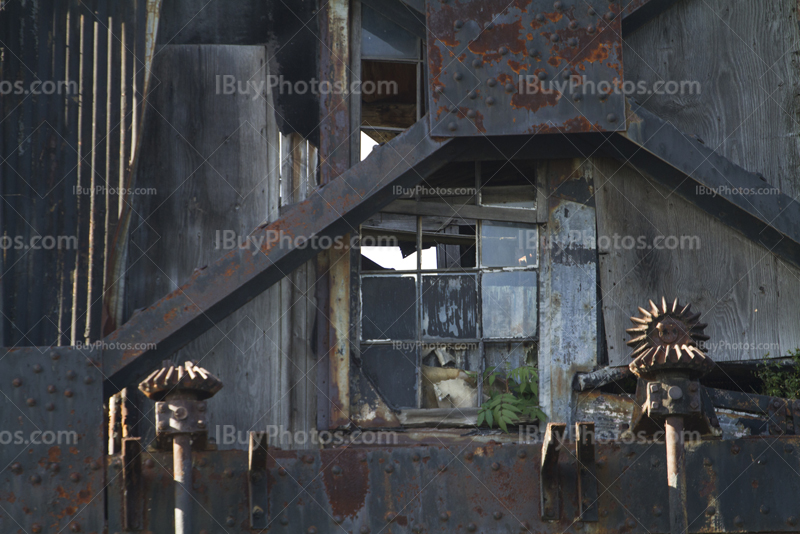 Broken windows and steel beams on rusty metal structure