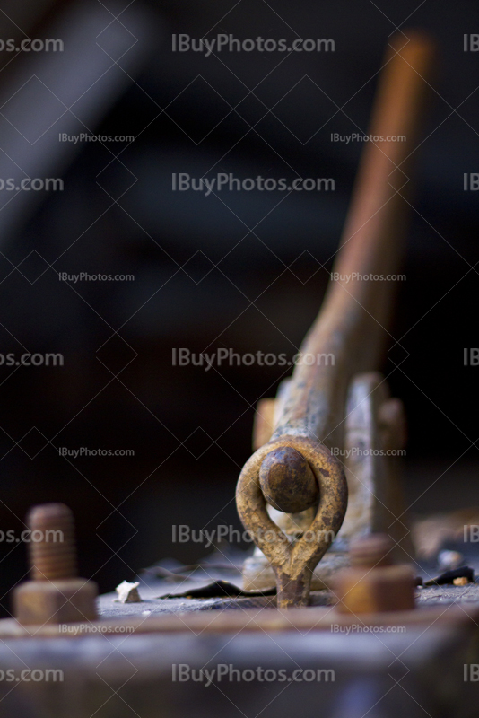 Rusty metal handle on plate with bolts