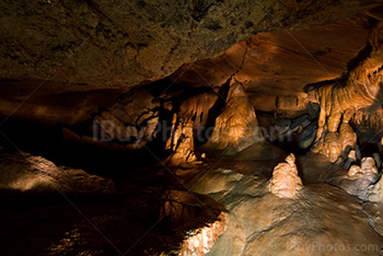 Lightpainting into cave with lights on stalactites and stalagmites