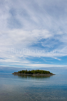 Small island in flat water of a river