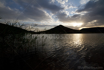 Salagou Lake sunset with sunlight reflection in water