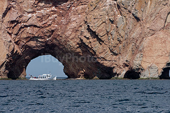 Boat in front of Perce rock in Gaspesie in Quebec, pierced rock