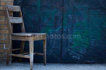 Chair in front of door with graffiti