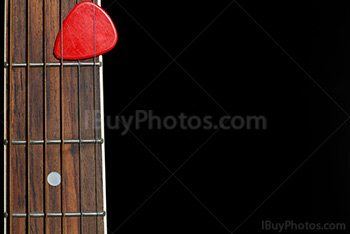 Plectrum on guitar with strings and fingerboard