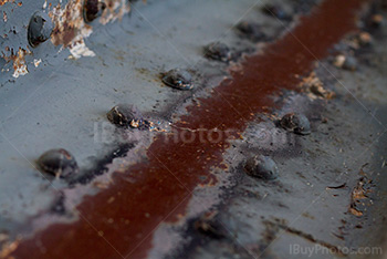 Metal beam with rusty bolts