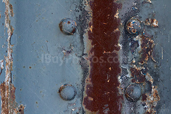 Rusty metal beam with bolts