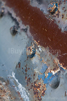 Rusty metal plate with bolts