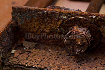 Old rusty bolt on metal plate