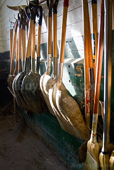 Shovels hang on wall in farm