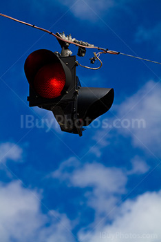 Road sign on wire with clouds in the sky