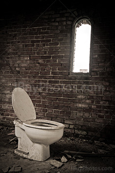 Old toilet in room with window