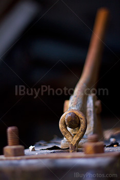 Rusty metal handle on plate with bolts