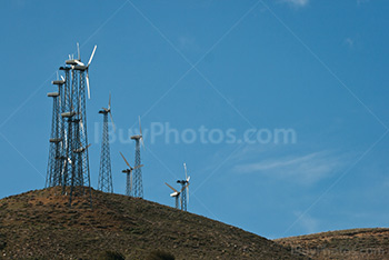 Windmills on hills on blue sky