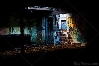 Abandoned factory with light on bricks walls with graffiti