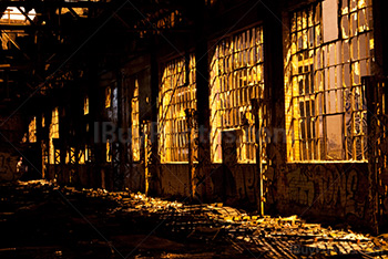 Light through broken windows into abandoned building at night