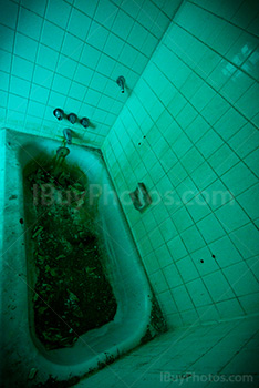 Creepy bathroom in abandoned asylum, green color photo