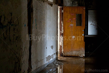 Abandoned school hallway with water on floor and reflection