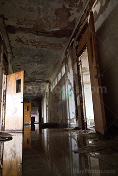 School corridor with open doors and water on floor