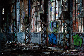 Derelict building interior with crumbling wall and broken windows