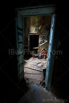 Doorway in dilapidated house dark room with graffiti