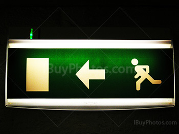 Green exit sign with door, arrow and man