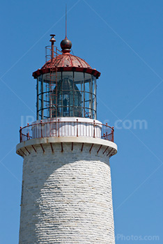 Lighthouse tower and lantern on blue sky