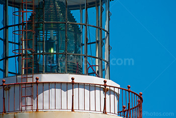 Lighthouse top with lantern and gallery, red metal stairs