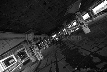 Parking lot perspective with concrete pillars and light from openings