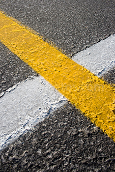 White and yellow road lines on asphalt