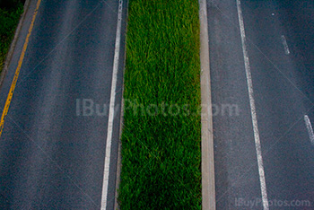 Road lines on the highway separated by grass median strip