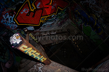 Dark staircase in abandoned building with graffiti