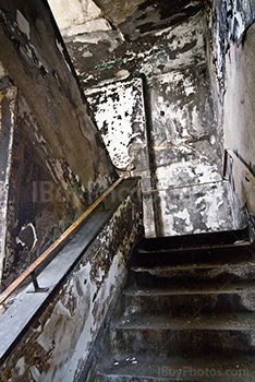 Stairs perspective with peeling walls in abandoned building