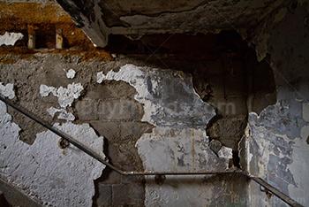 Damaged wall with rusty banister