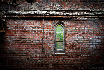 Old window on damaged bricks wall